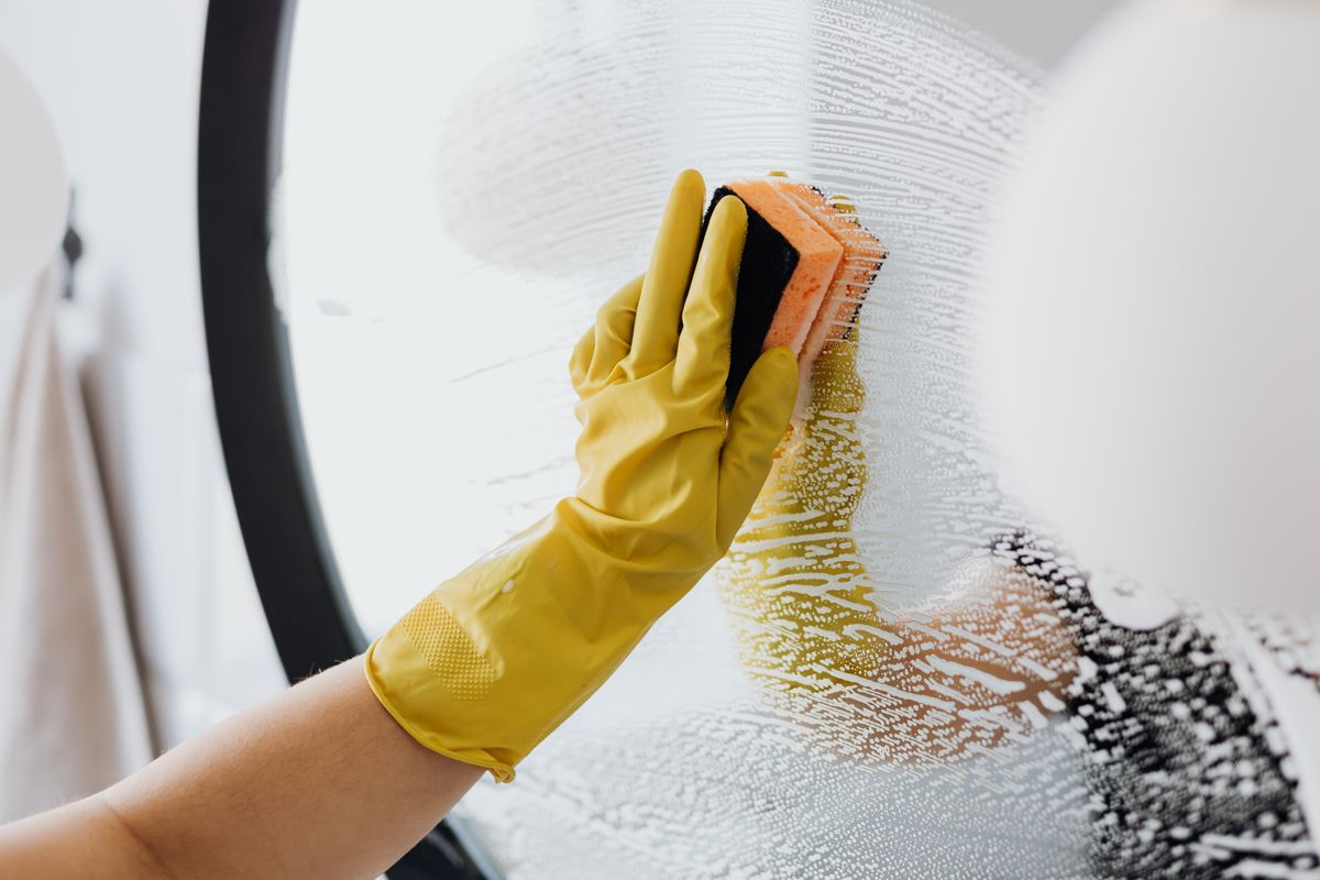 Temporary stock photo of glass being cleaned as a closeout detail.